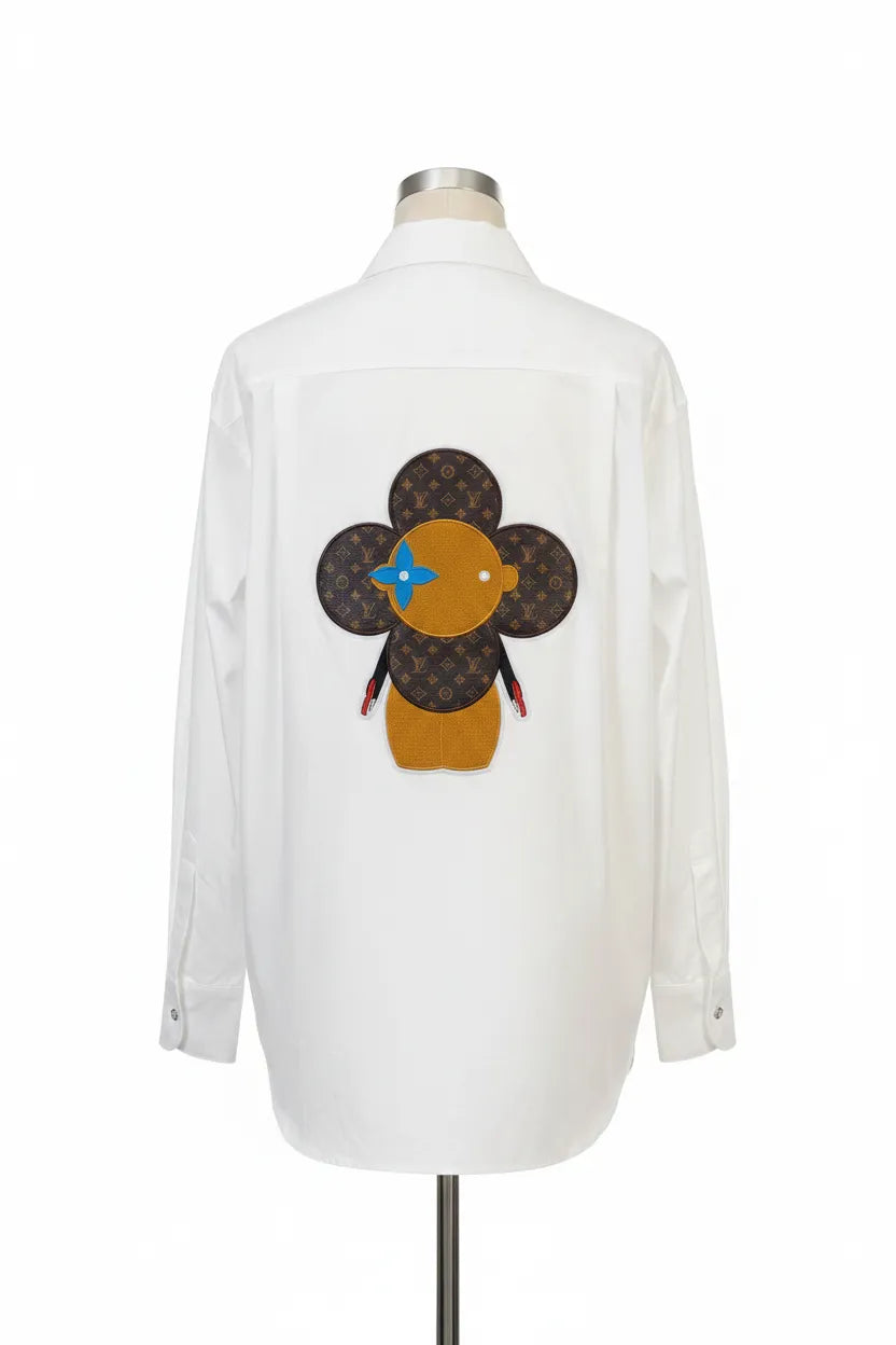 White shirt with a decorative flower design on a mannequin against a white background